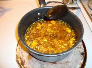 a saute pan cooking pumpkin pulp to make pumpkin spice syrup